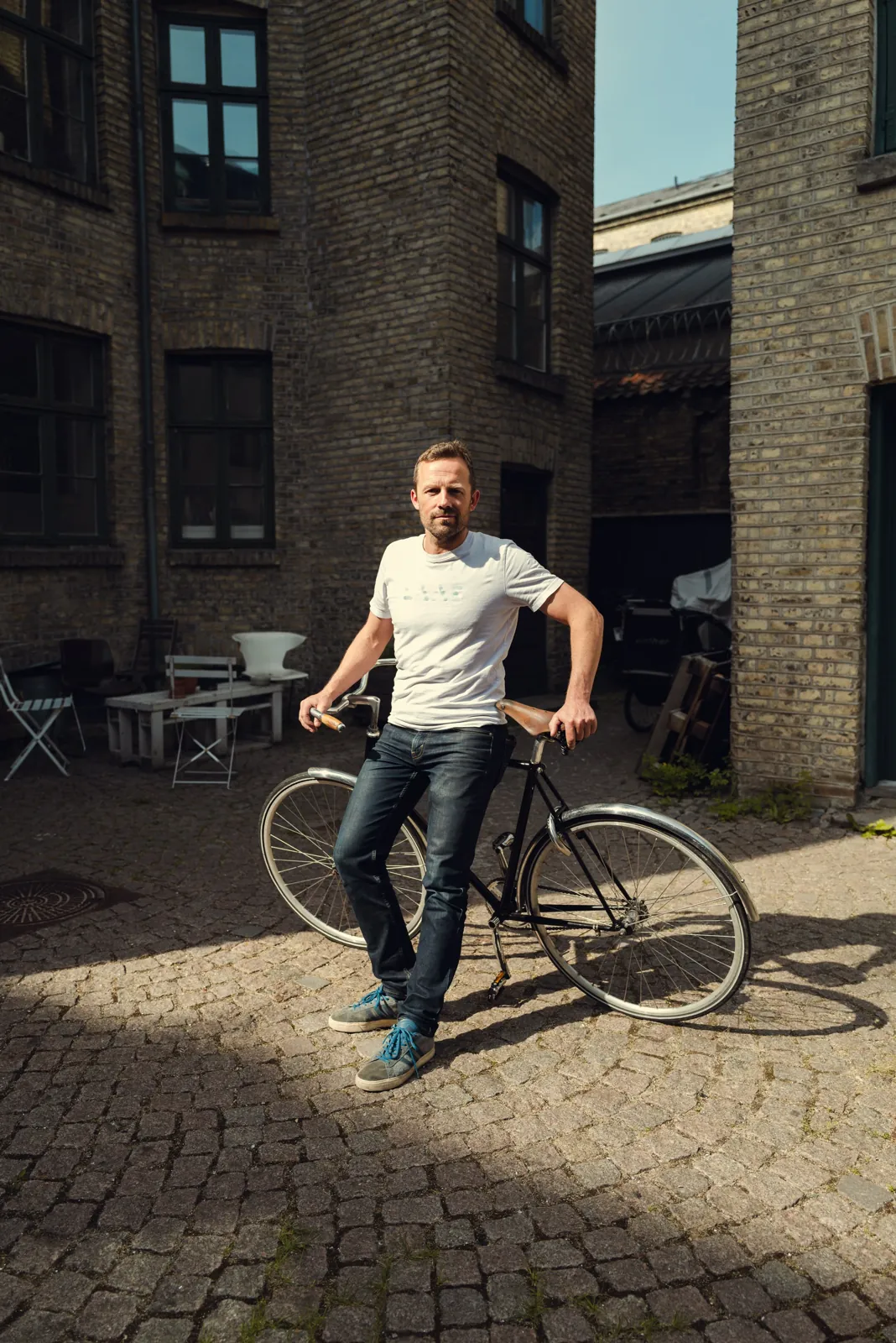 Marcus Kjellsson, founder of LAAS, with his bike in a Copenhagen courtyard